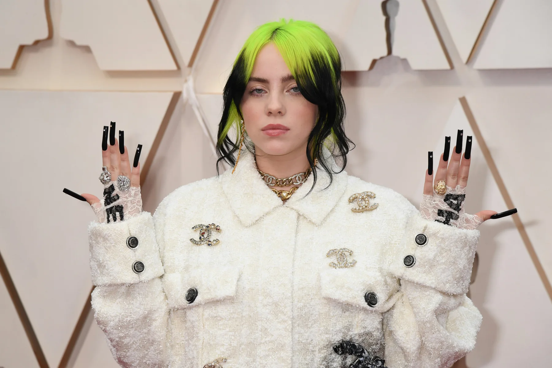 Billie Eilish wearing neon green roots with black hair in a loose updo at the 2020 Oscars