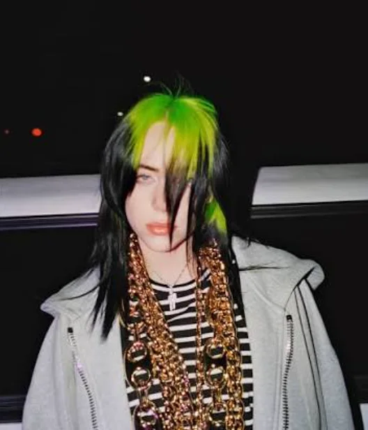 Billie Eilish with acid-green roots and long straight black hair