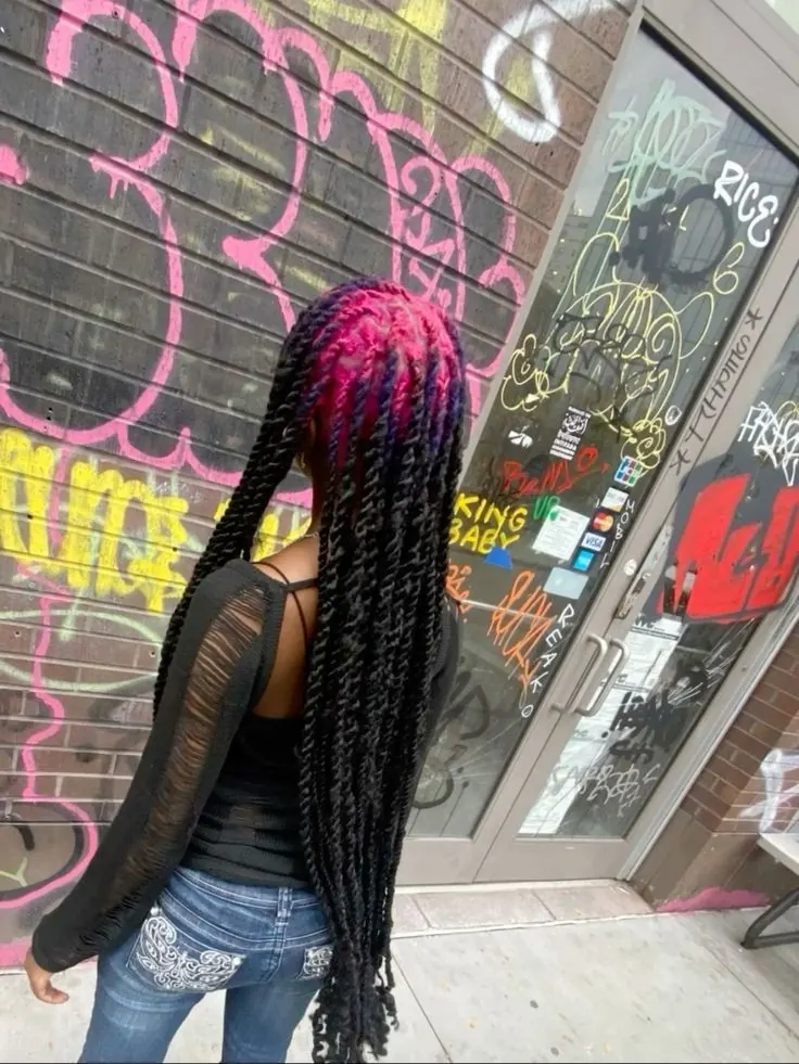 Back view of long black box braids with magenta-pink color across the crown roots and braided rows.
