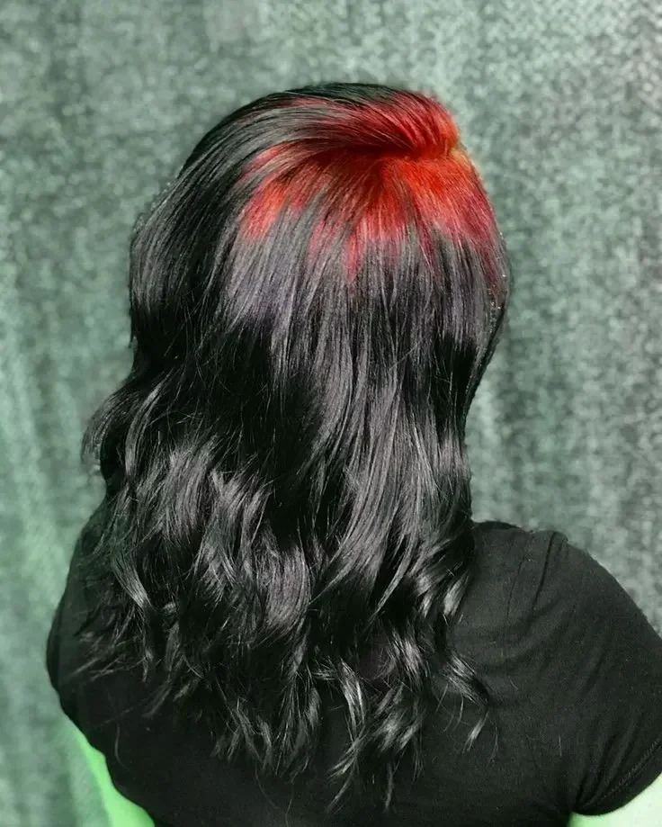 Back view of long black waves with a crimson-red panel beginning at the top of the crown.