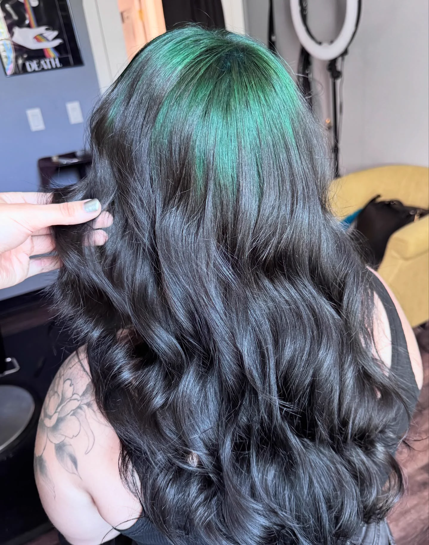 Back view of long black wavy hair with a broad teal crown panel.