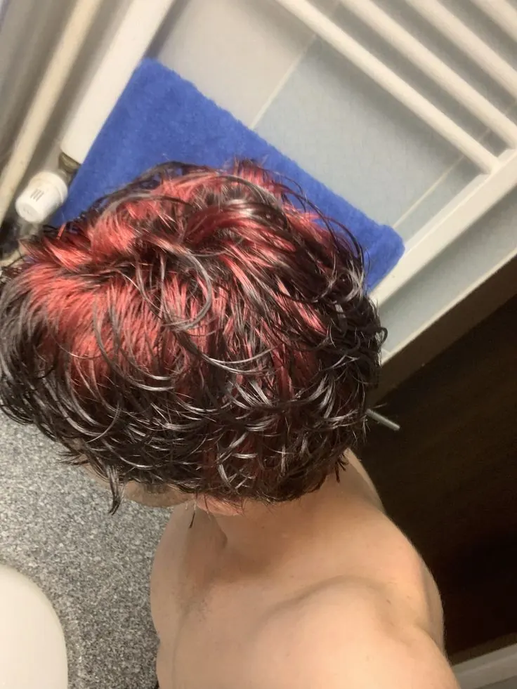 black men's medium wavy cut with burgundy red ghost roots.