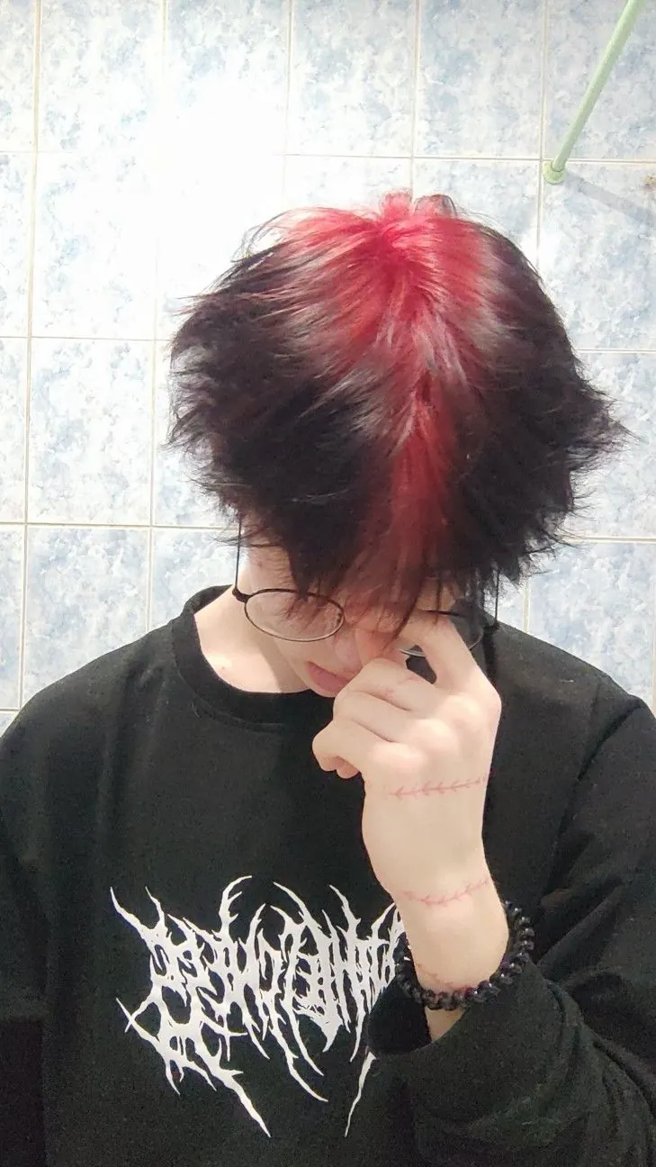 black men's shag cut with crimson red ghost roots.
