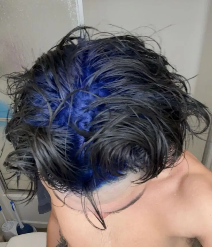 black men's medium wavy layered cut with electric blue ghost roots.