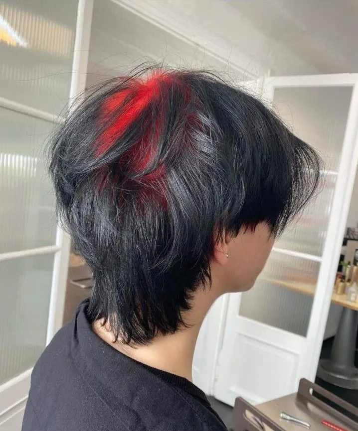 charcoal black men's wolf cut mullet with red ghost roots.