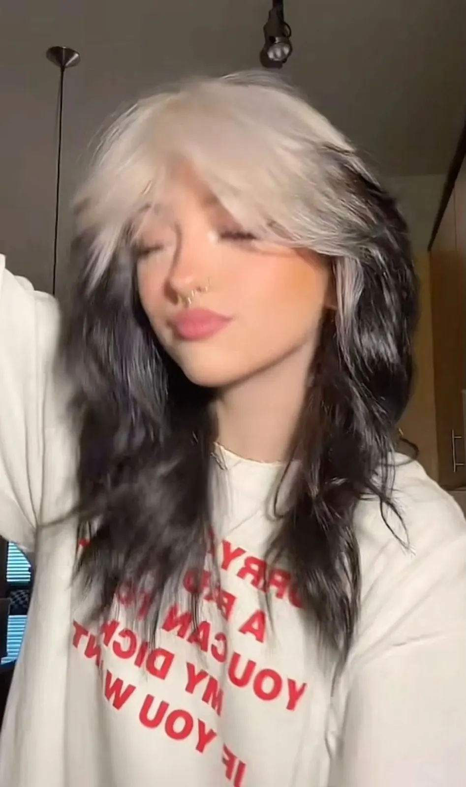 Long black loose waves with silver-white ghost roots and money-piece contrast.