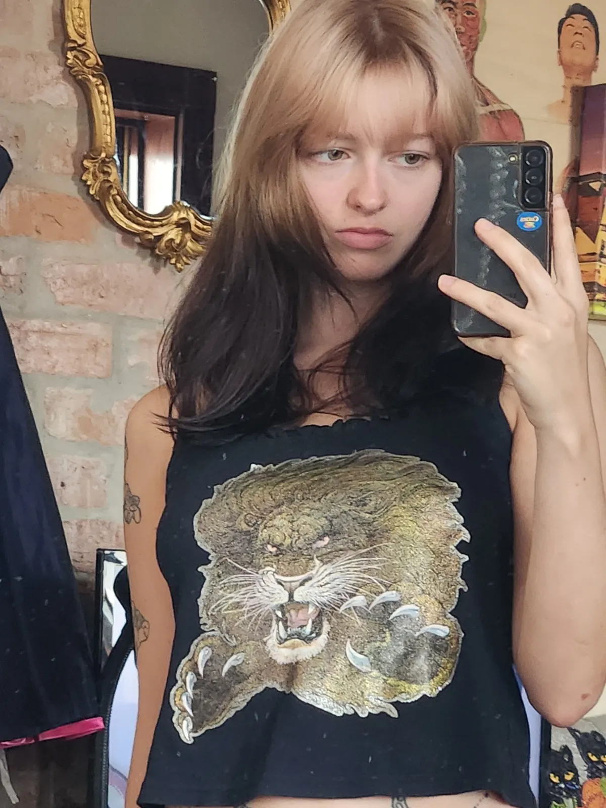 Dark brown shoulder-length hair with soft beige blonde ghost roots and curtain bangs.