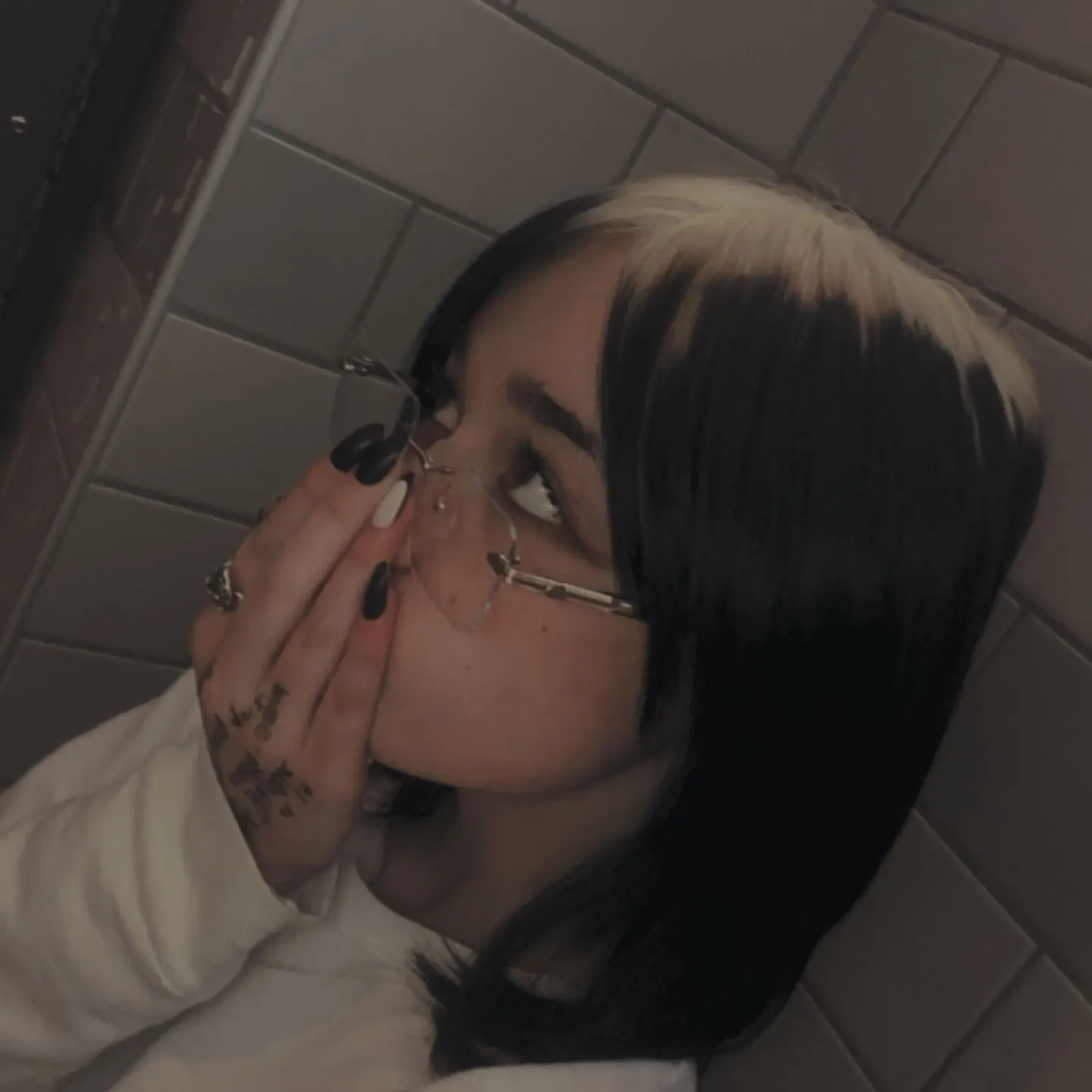 Black hair with Taupe Blonde ghost roots, Short Sleek Bob, Mirror Selfie.