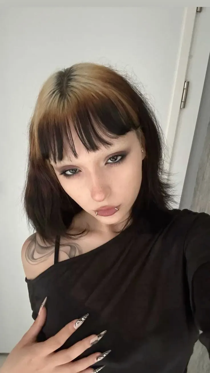 Medium brown straight hair with soft beige blonde ghost roots and face-framing bangs.