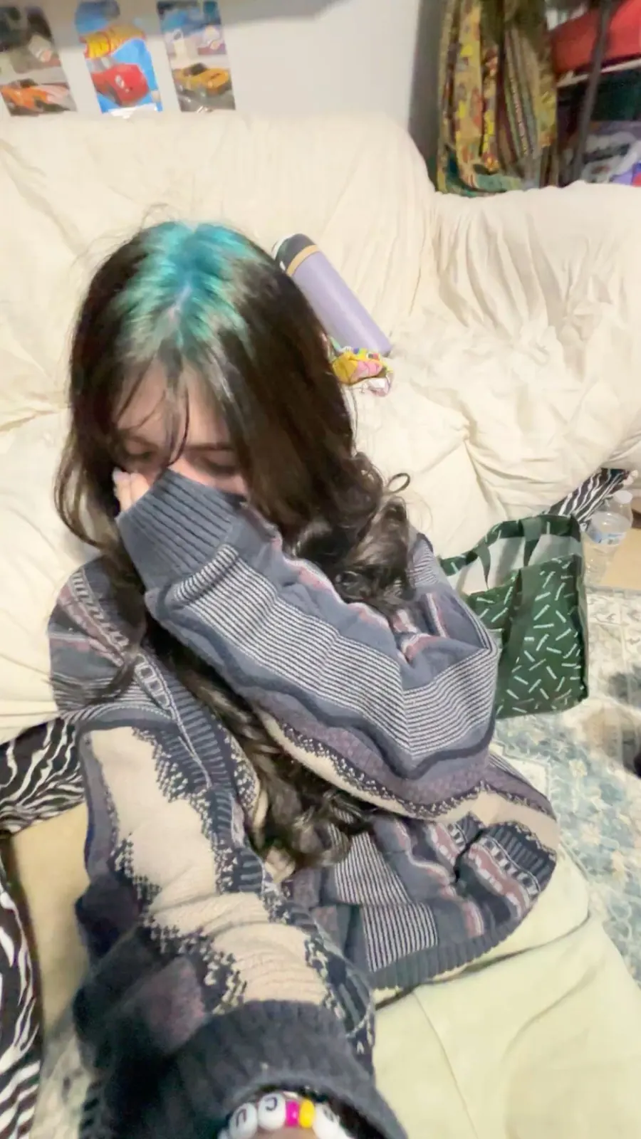 Long brown straight hair with teal-blue ghost roots through a covered crown panel.