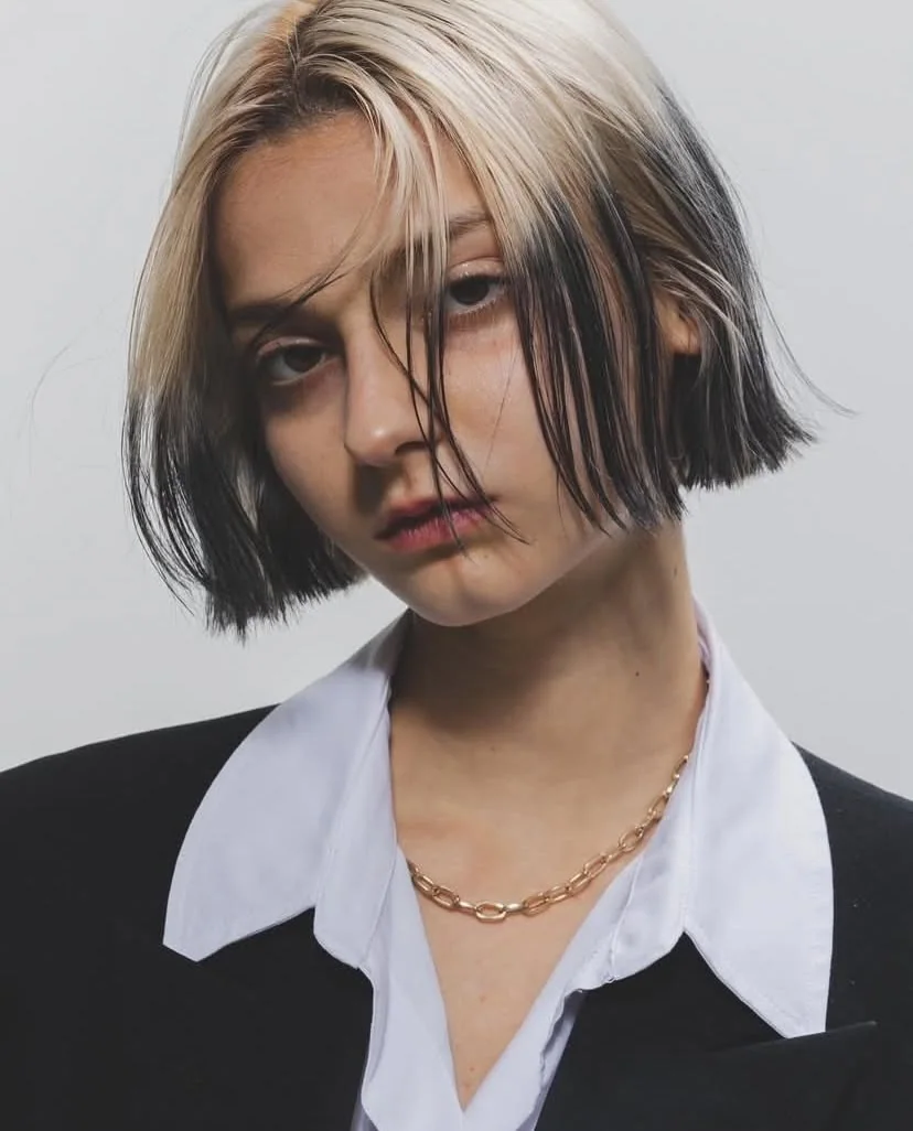 Short textured bob with piecey fringe and silver-white ghost roots.