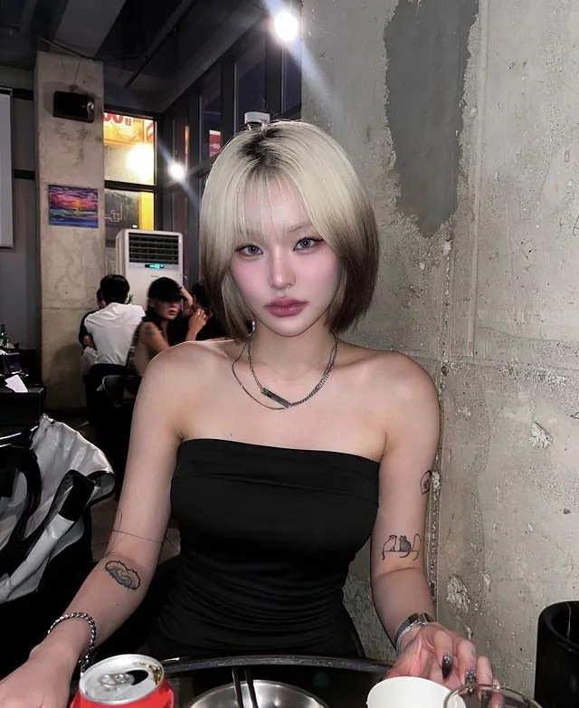 Short chin-length bob with platinum-silver top and black underlayer.